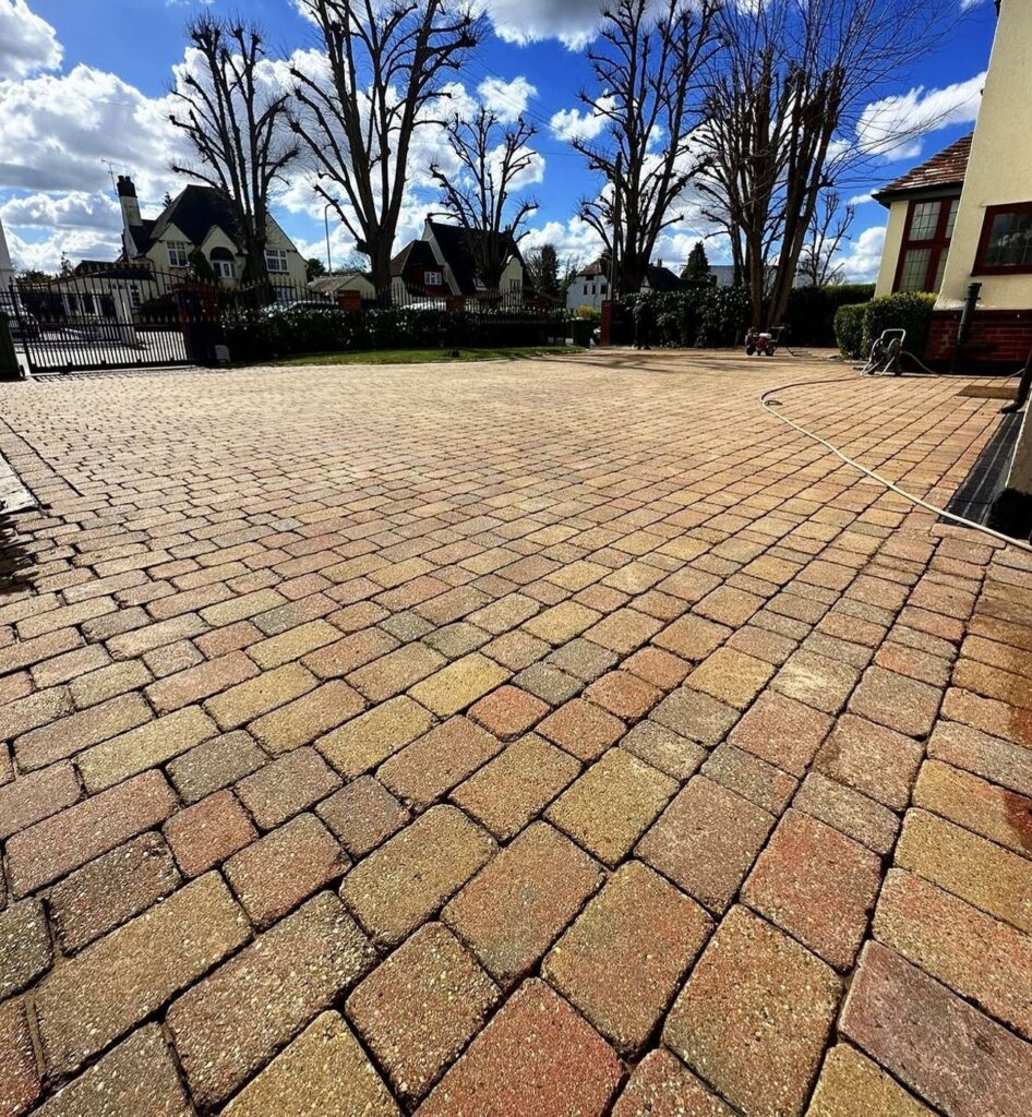 Clean block paving in front of a large house
