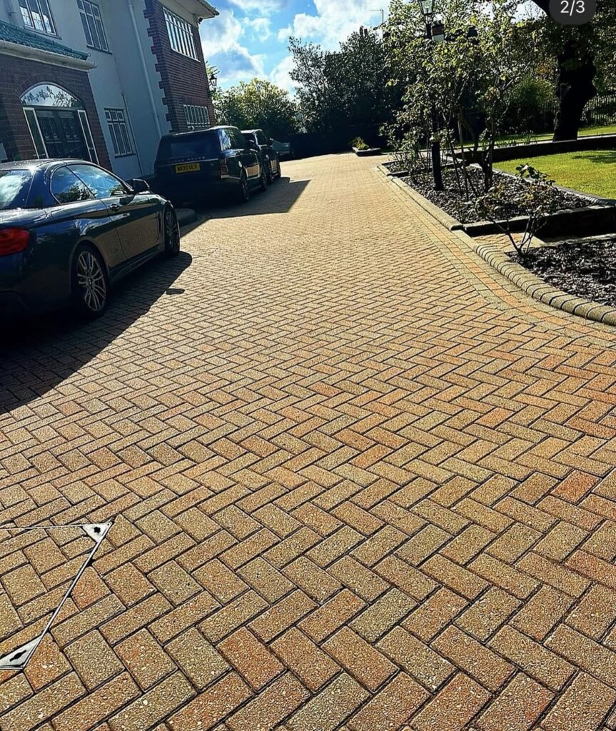 Freshly cleaned herringbone block paving driveway